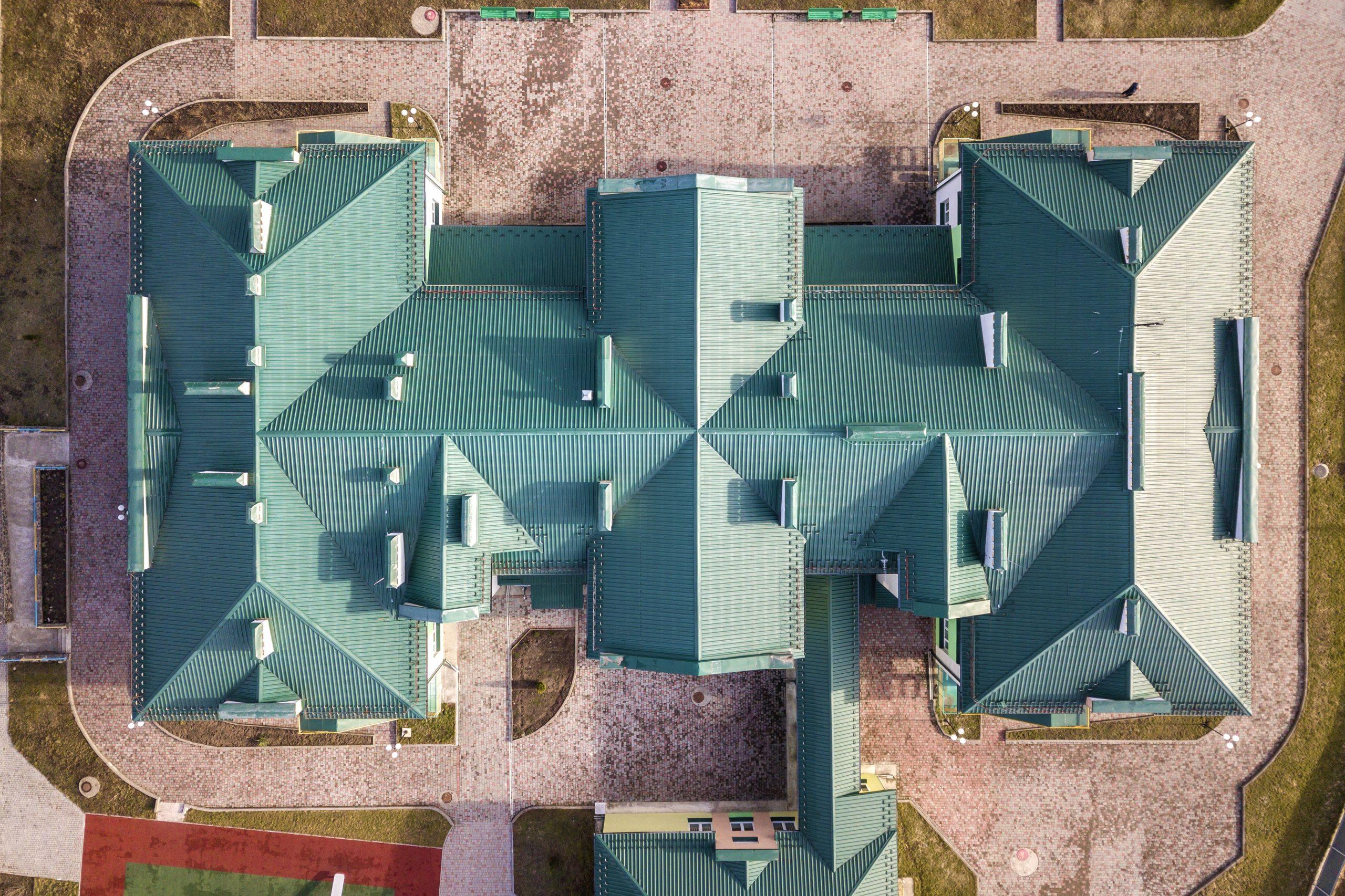 top aerial view of building green shingle tiled ro 2023 01 31 01 03 30 utc scaled