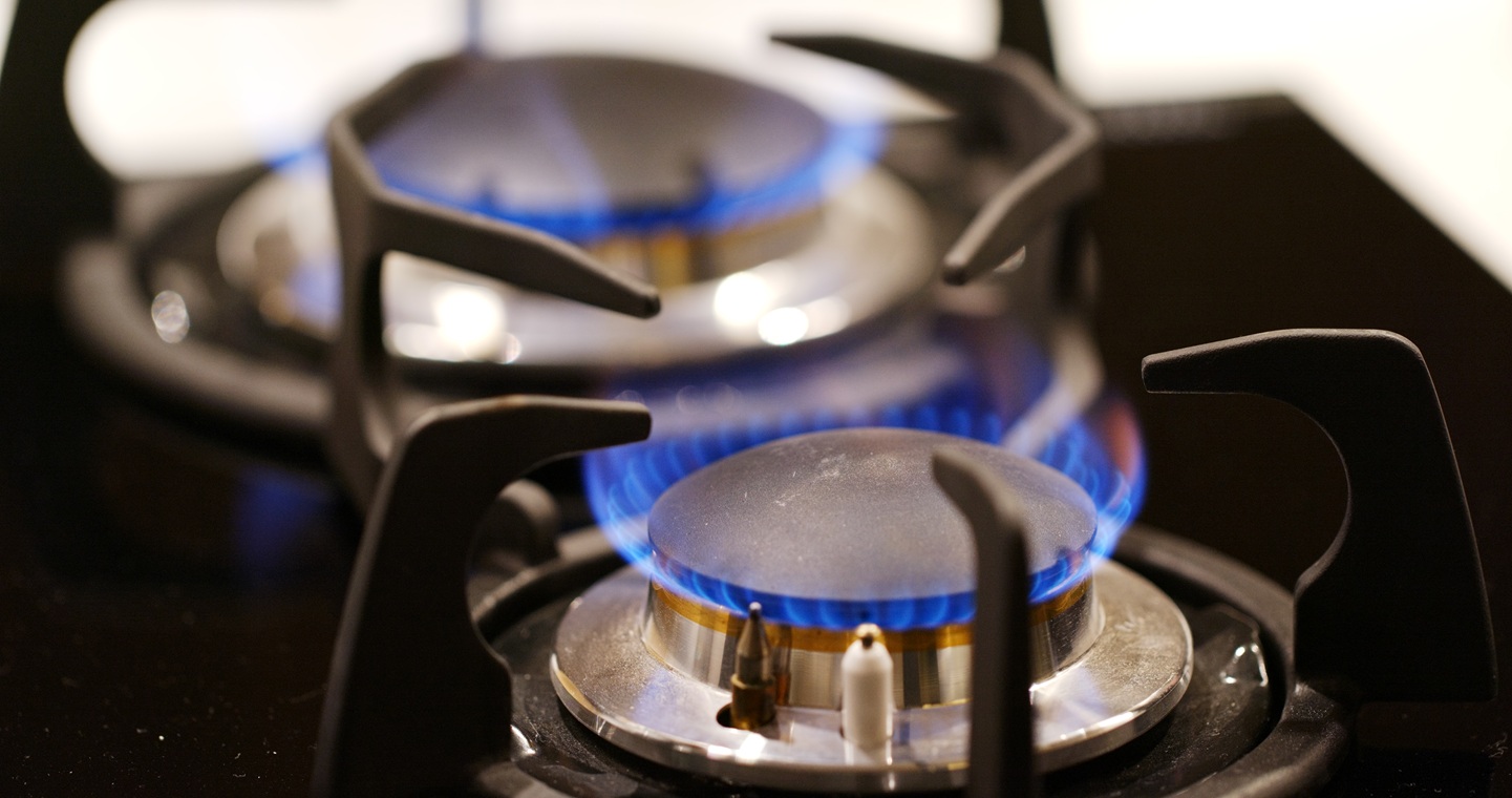 two burner flames from a gas stove. The flames are blue.