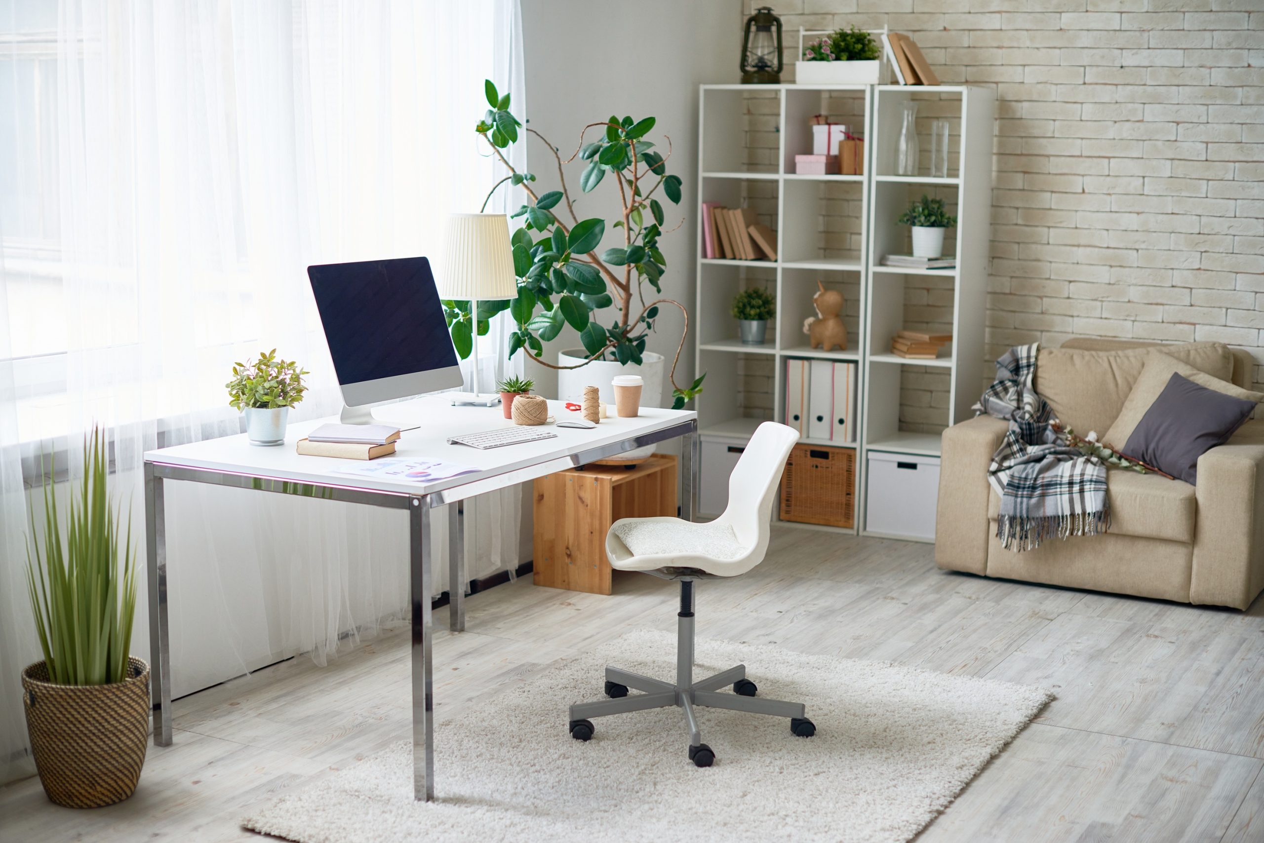 a white office chair in front of a desk, sitting in a what appears to be a bedroom.