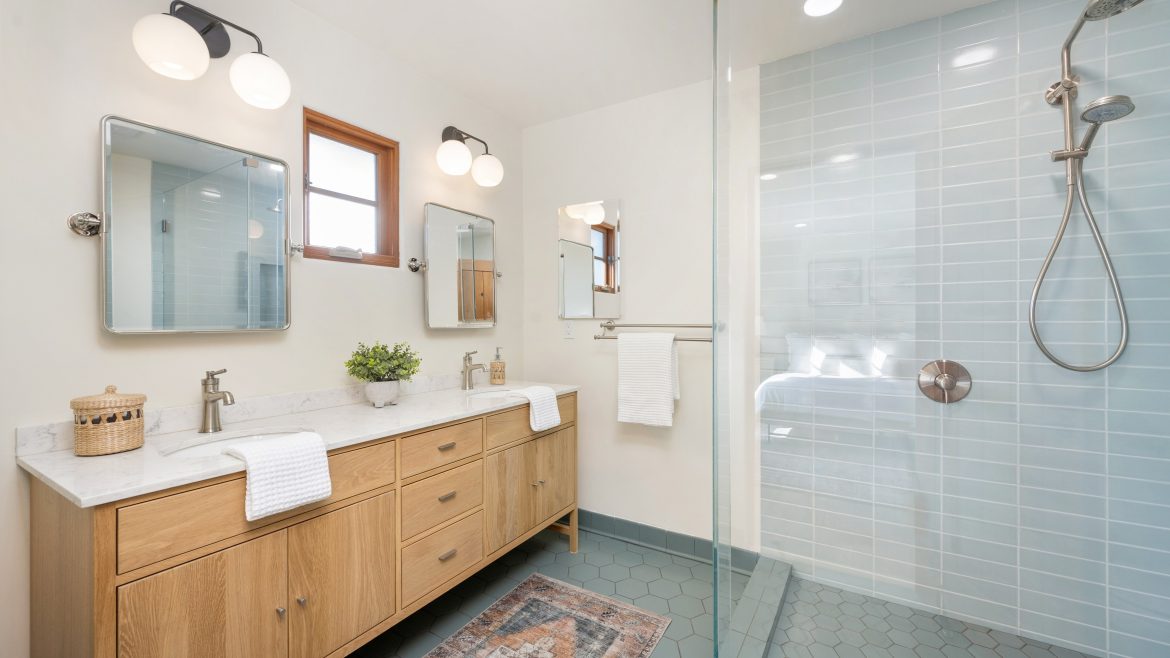 a white bathroom with tiled walls and wood cabinet 2025 02 11 19 46 06 utc